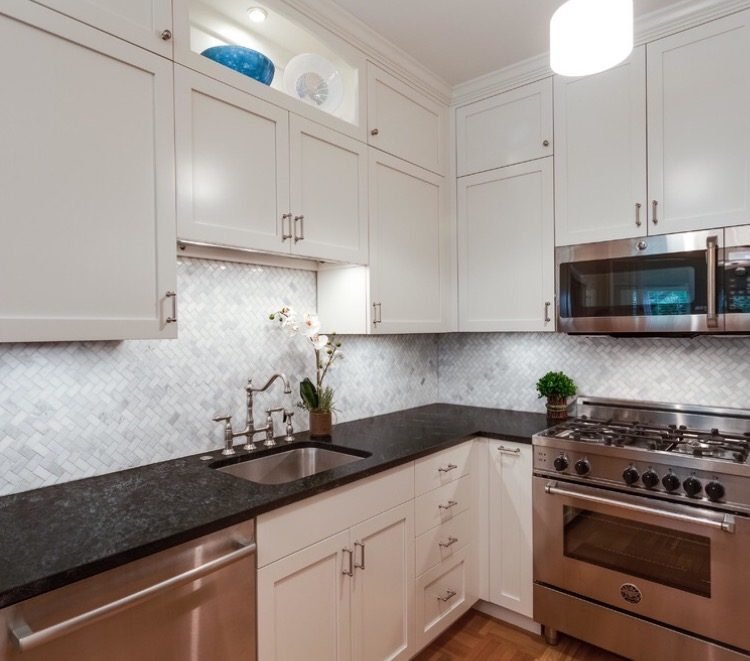 White kitchen with black granite