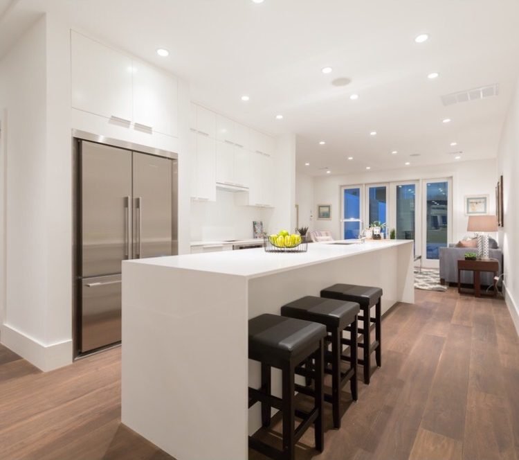 Open-plan kitchen with white island