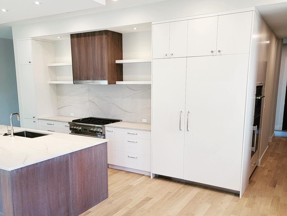 White kitchen with wood range hood